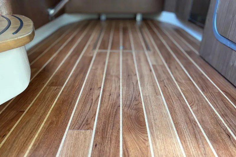 Slide: The Image of Teak flooring on 2011 Chaparral 330 Signature boat interior. - 37