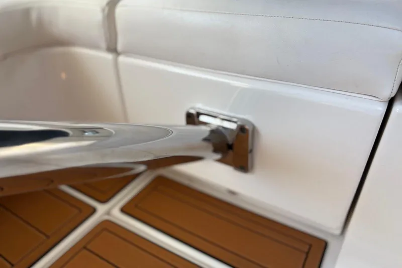 Slide: The Image of Close-up of 2011 Chaparral 330 Signature boat interior, featuring sleek metal railing and cushioned seating. - 39