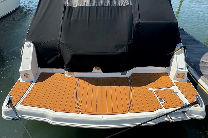 Slide: The Image of 2011 Chaparral 330 Signature boat with teak swim platform and black cover. - 4