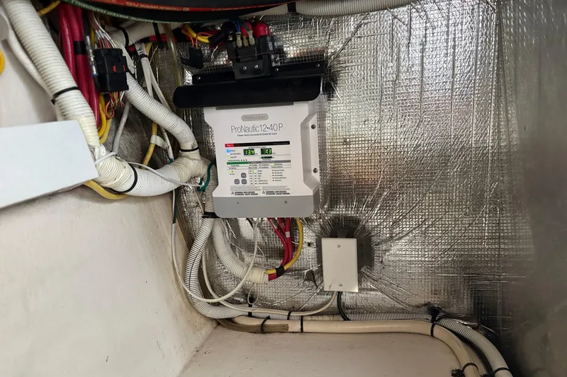 Slide: The Image of Electrical system inside 2011 Chaparral 330 Signature boat, featuring ProNautic charger. - 46