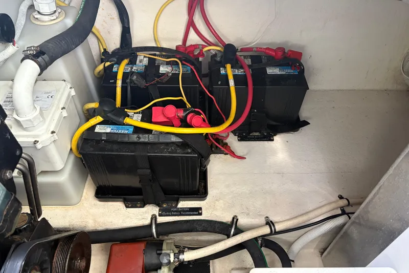 Slide: The Image of 2011 Chaparral 330 Signature boat battery compartment with wiring and components. - 49