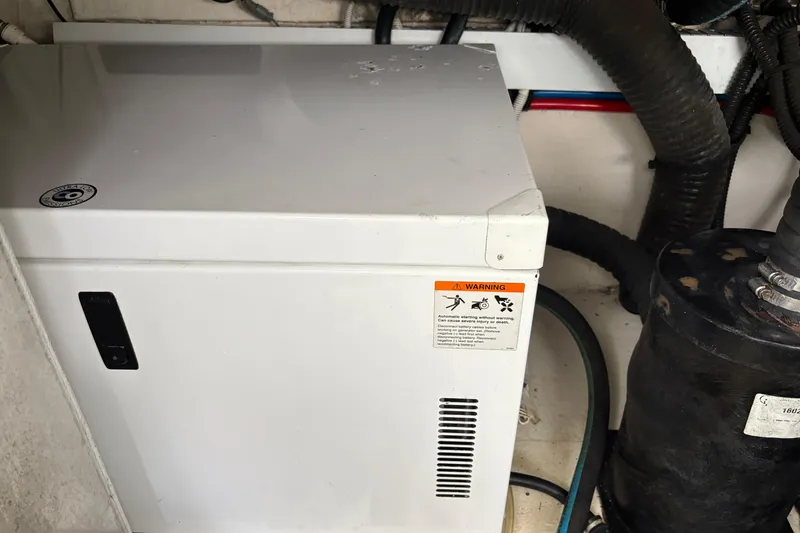 Slide: The Image of Engine compartment of 2011 Chaparral 330 Signature with warning label and equipment. - 50