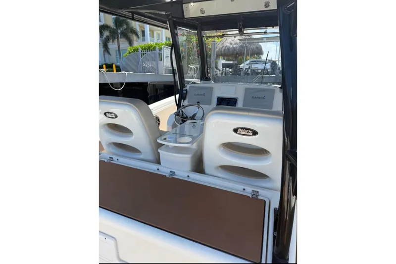 Slide: The Image of 2015 Cobia 344 Center Console boat interior with helm seats and Garmin electronics. - 3