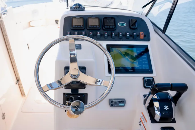 Slide: The Image of 2007 Grady-White Tournament 275 boat dashboard with steering wheel and navigation controls. - 10