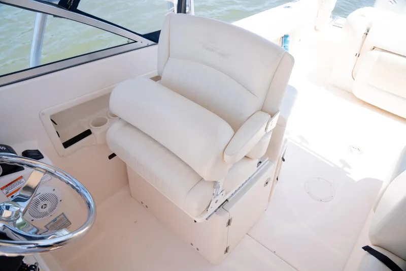 Slide: The Image of 2007 Grady-White Tournament 275 boat interior with white captain's chair and steering wheel. - 13