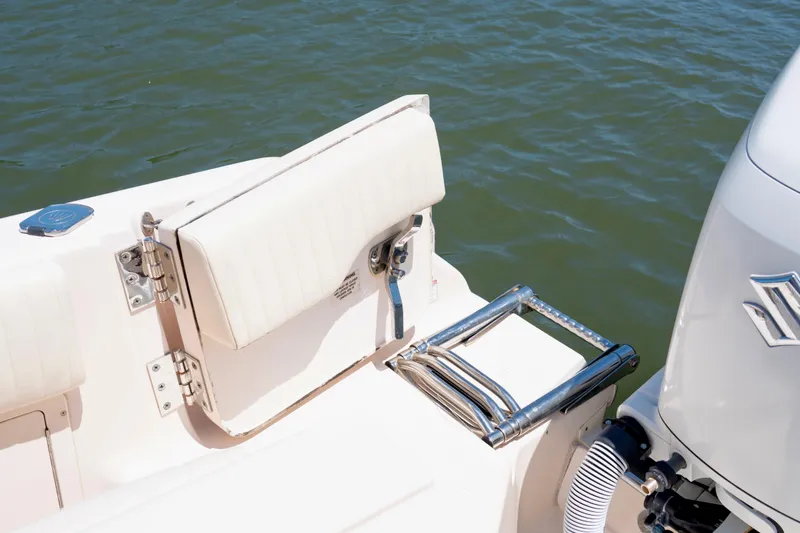 Slide: The Image of 2007 Grady-White Tournament 275 boat with swim ladder and outboard motor on water. - 16