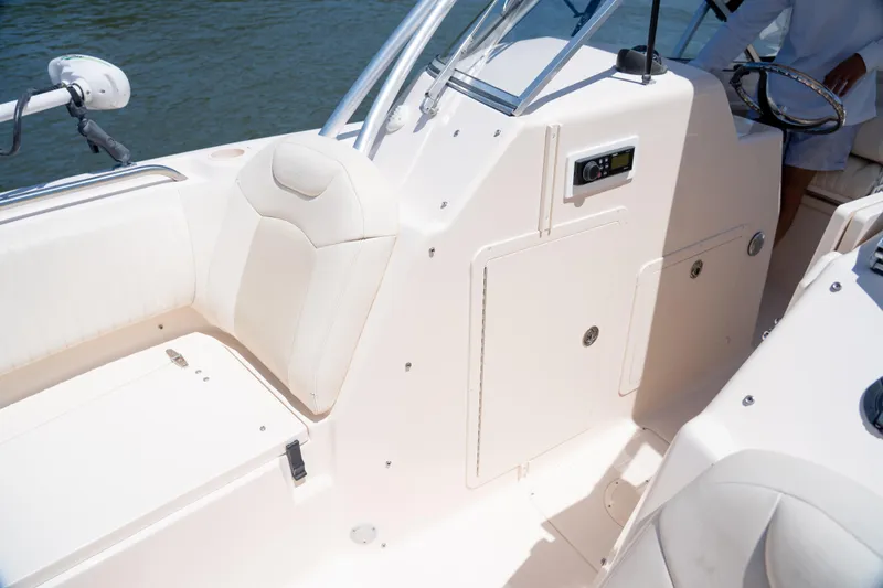 Slide: The Image of 2007 Grady-White Tournament 275 boat interior with white seating and control panel. - 17