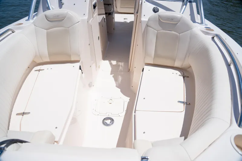 Slide: The Image of 2007 Grady-White Tournament 275 boat interior with white seating and storage compartments. - 19