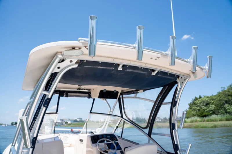 Slide: The Image of 2007 Grady-White Tournament 275 boat with rod holders, clear sky, and scenic waterway. - 21