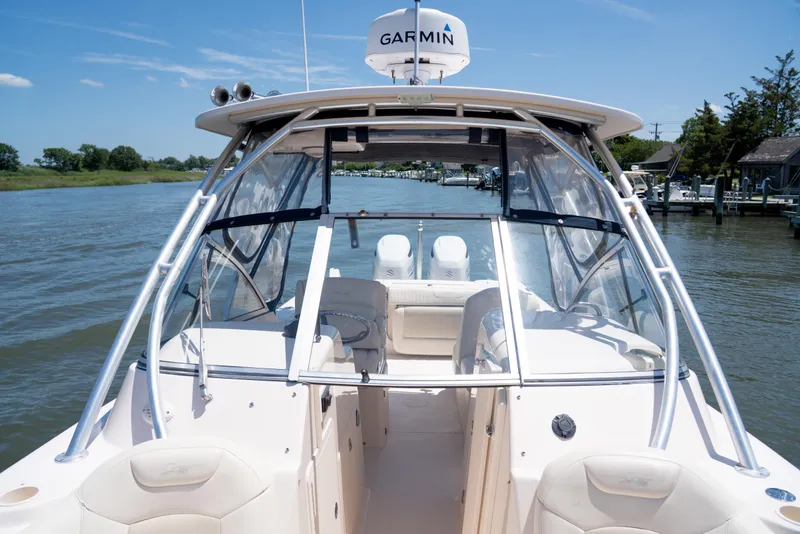 Slide: The Image of 2007 Grady-White Tournament 275 boat on a calm river, featuring Garmin equipment. - 22