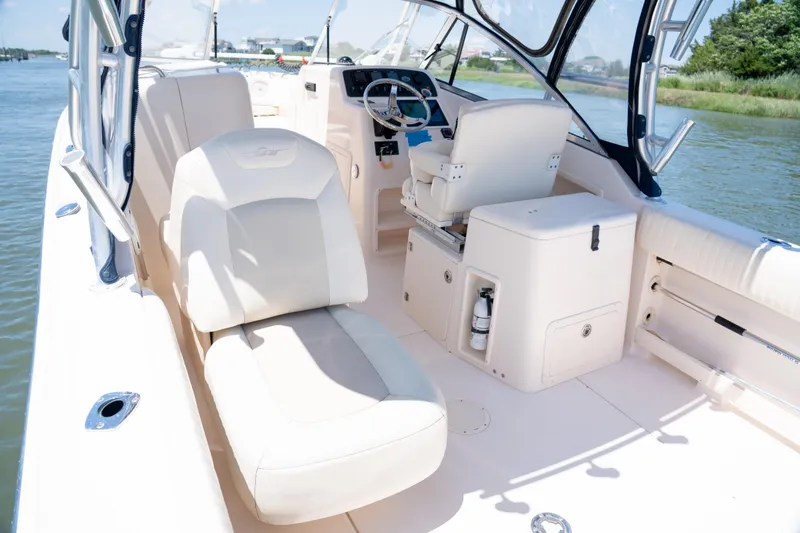 Slide: The Image of 2007 Grady-White Tournament 275 boat interior with helm and seating, on calm water. - 7