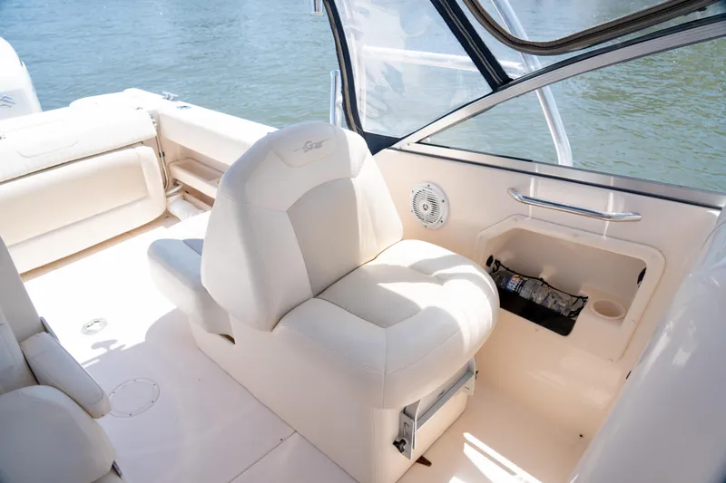 Slide: The Image of 2007 Grady-White Tournament 275 boat interior with white seating and storage compartment. - 8