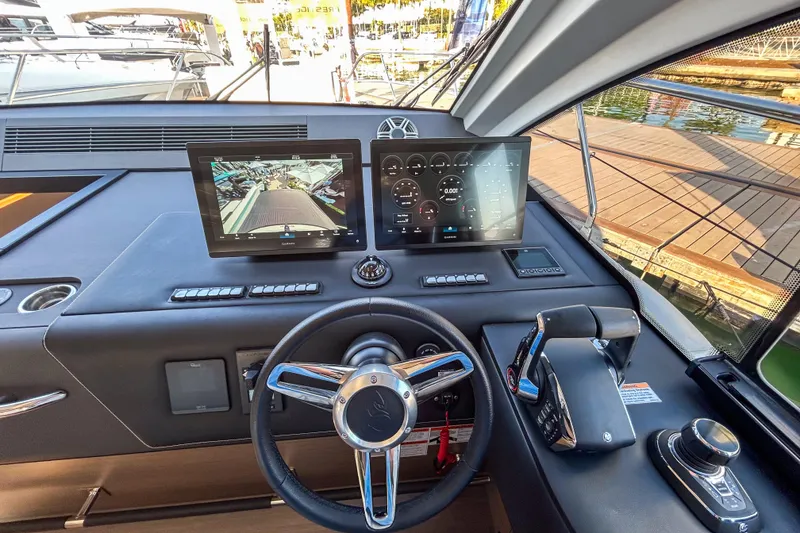 Slide: The Image of Helm of 2026 Beneteau Gran Turismo 40 with advanced navigation displays and controls. - 1