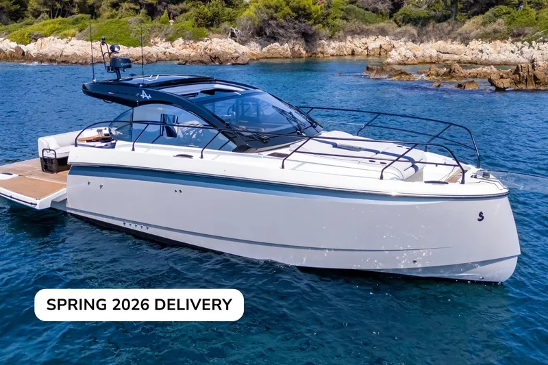 Slide: The Image of 2026 Beneteau Gran Turismo 40 yacht on water, spring delivery, scenic coastal backdrop. - 10