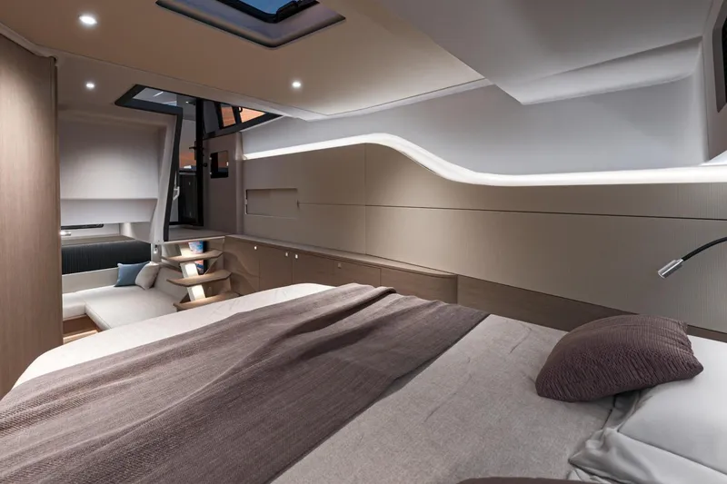 Slide: The Image of Luxurious interior of 2026 Beneteau Gran Turismo 40 yacht, featuring modern design and cozy bedding. - 14