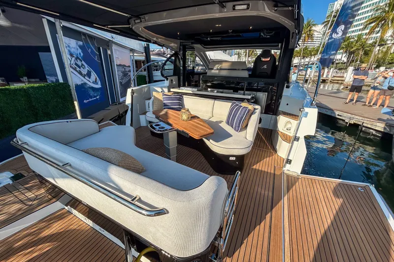 Slide: The Image of 2026 Beneteau Gran Turismo 40 yacht interior with elegant seating and wooden deck. - 9