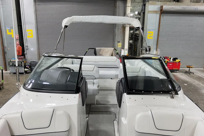 Slide: The Image of 2026 Formula 240 Bowrider boat in a warehouse, featuring sleek design and spacious seating. - 44
