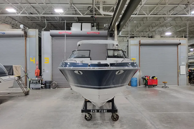 Slide: The Image of 2026 Formula 240 Bowrider boat in a spacious indoor facility. - 5