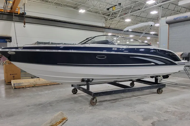 The Image of 2026 Formula 270 Bowrider boat in a warehouse setting, side view. - 1