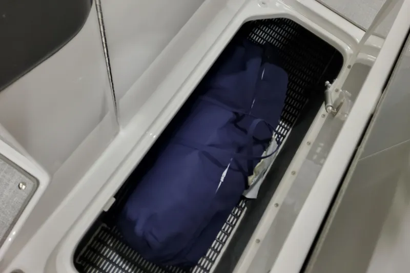 Slide: The Image of Storage compartment in 2026 Formula 270 Bowrider boat with blue cover inside. - 24