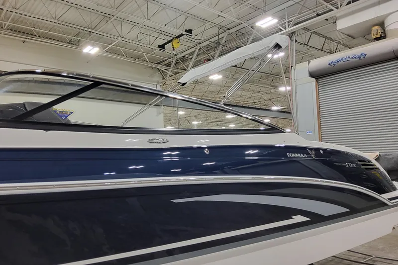 Slide: The Image of 2026 Formula 270 Bowrider boat in showroom, showcasing sleek design and modern features. - 7