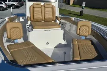 Slide: The Image of 2026 Caymas 291 boat interior with tan leather seating and modern design. - 10