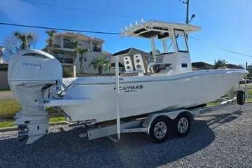 Slide: The Image of 2026 Caymas 291 boat with Yamaha engine, parked on a trailer under clear blue sky. - 3