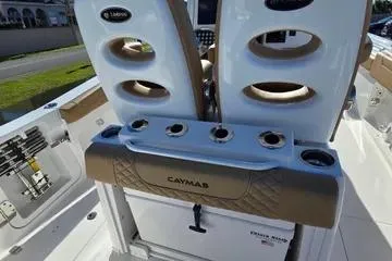 Slide: The Image of 2026 Caymas 291 boat interior with rod holders and storage compartments. - 7