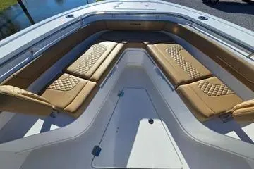Slide: The Image of 2026 Caymas 291 boat interior with tan cushioned seating and sleek design. - 8