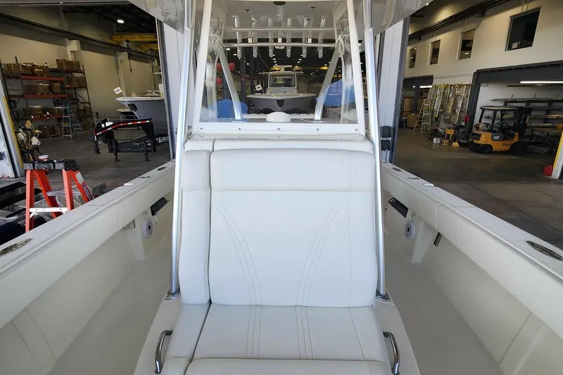 Slide: The Image of 2012 SeaVee 340B boat interior with white seating in a workshop setting. - 10