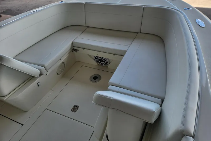 Slide: The Image of 2012 SeaVee 340B boat interior with cushioned seating and storage compartments. - 12