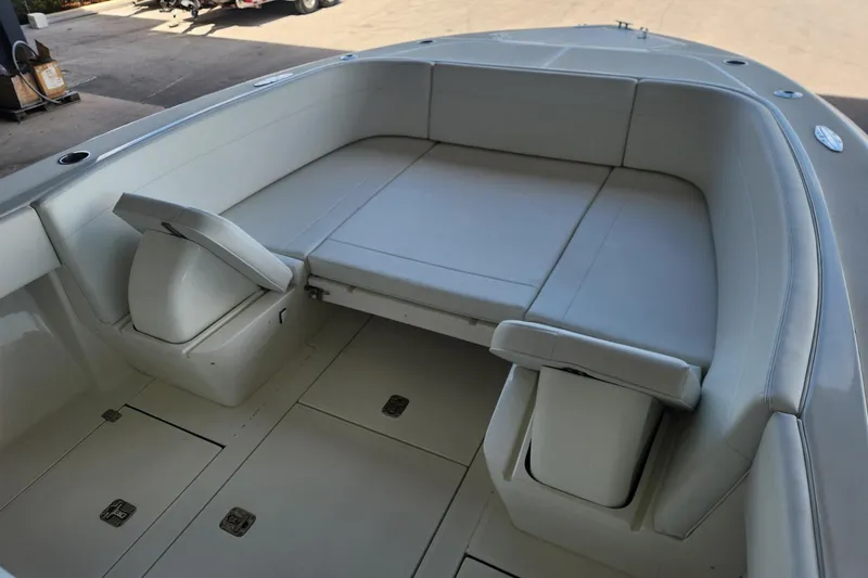 Slide: The Image of 2012 SeaVee 340B boat interior with cushioned seating and storage compartments. - 13