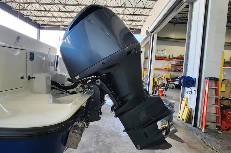 Slide: The Image of 2012 SeaVee 340B boat with powerful outboard motor in a garage setting. - 15