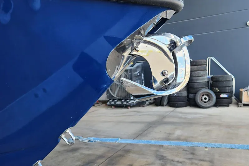 Slide: The Image of Close-up of a 2012 SeaVee 340B boat anchor, with a blue hull and chrome details. - 16
