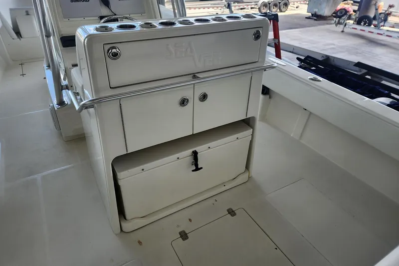 Slide: The Image of 2012 SeaVee 340B boat interior with storage compartments and rod holders. - 8