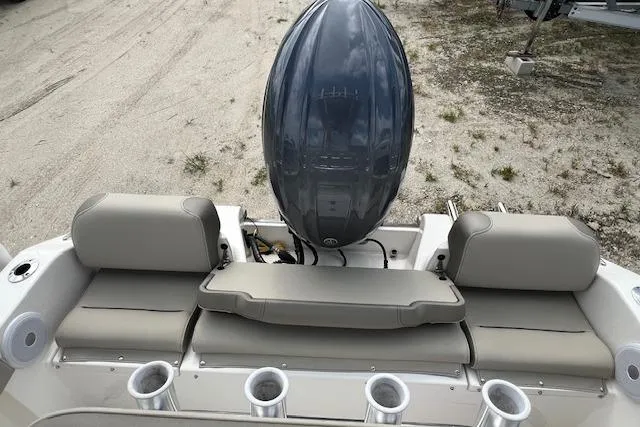 Slide: The Image of 2023 Key West 189 FS boat with cushioned seating and outboard motor. - 2