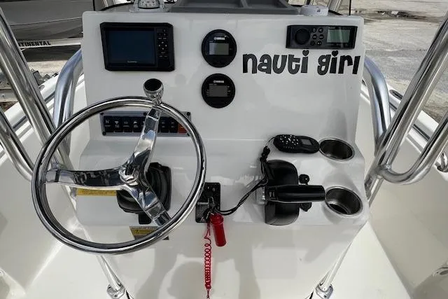 Slide: The Image of 2023 Key West 189 FS boat dashboard with steering wheel and navigation instruments. - 4