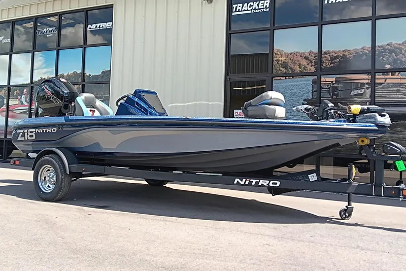 Slide: The Image of 2026 Nitro Z18 boat on trailer outside dealership, showcasing sleek design and modern features. - 2