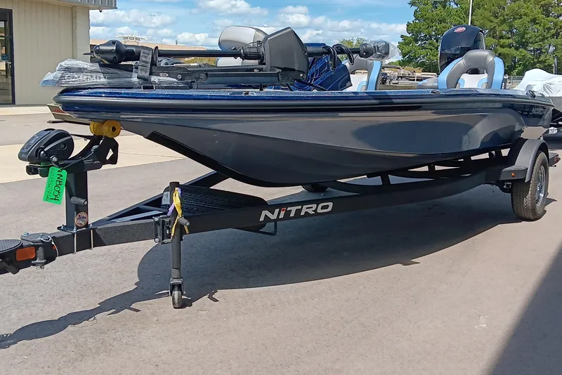 Slide: The Image of 2026 Nitro Z18 boat on trailer, parked outdoors under clear sky. - 4