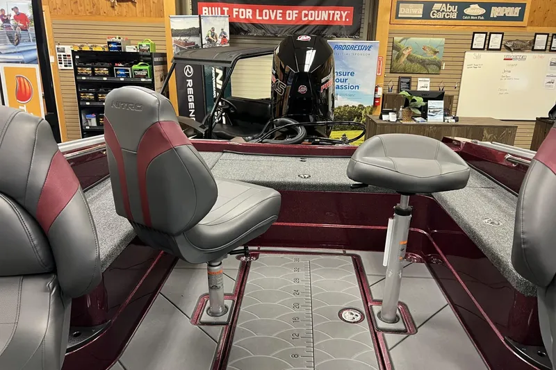 Slide: The Image of 2026 Nitro ZV20 Pro boat interior with gray and maroon seating in showroom. - 5