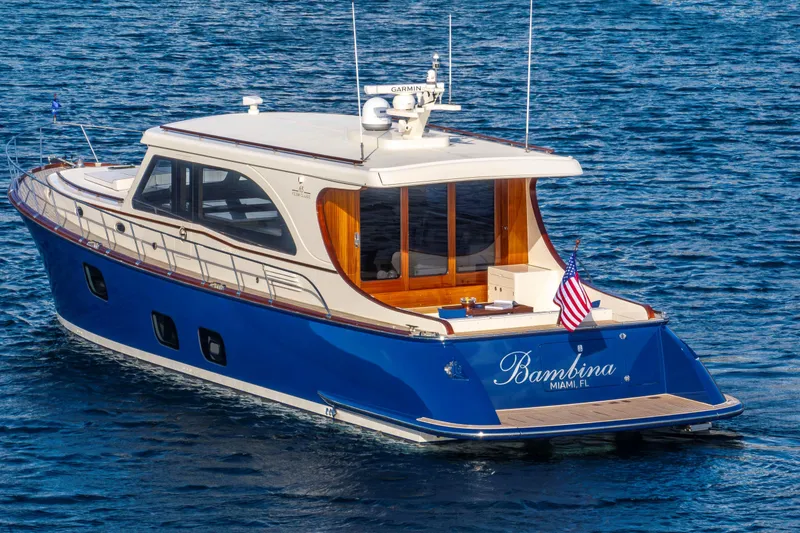 The Image of 2025 Vicem 65 Classic yacht on blue water, rear view with American flag. - 1