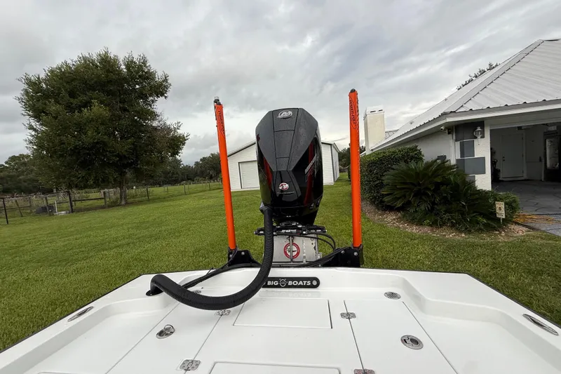 Slide: The Image of Boat with motor in backyard, Big O Elite 20, 2021 model, overcast sky. - 14