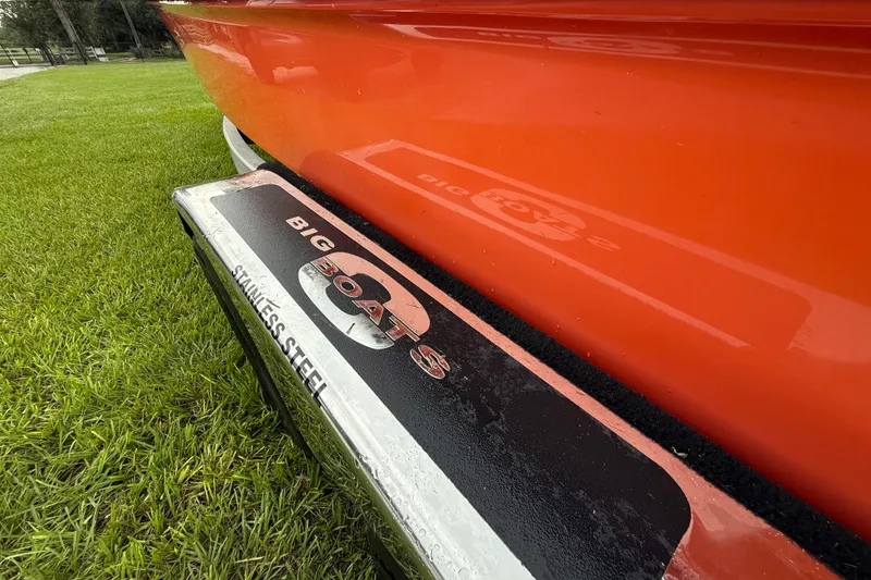 Slide: The Image of Orange Big O Elite 20 boat with stainless steel step, 2021 model, on grass. - 20