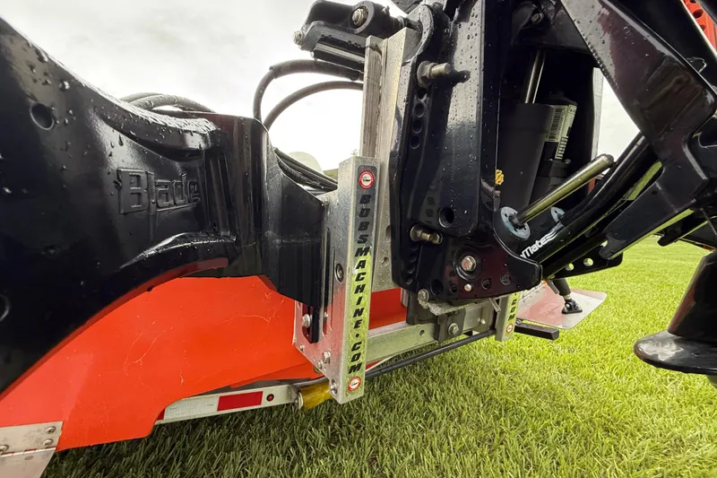 Slide: The Image of Close-up of Big O Elite 20 machinery part on grass, showcasing mechanical details. - 21