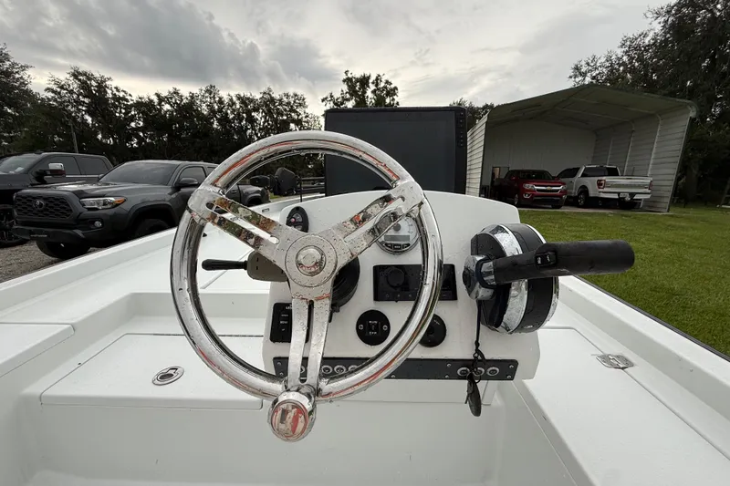 Slide: The Image of Steering console of a 2021 Big O Elite 20 boat, parked outdoors. - 25