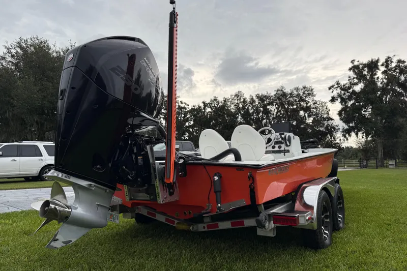 Slide: The Image of 2021 Big O Elite 20 boat with powerful outboard motor on a grassy area. - 26