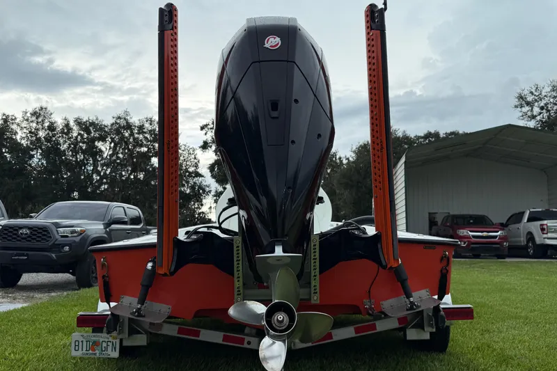 Slide: The Image of Rear view of a 2021 Big O Elite 20 boat on a trailer, parked outdoors. - 27