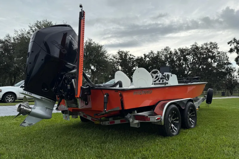 Slide: The Image of Orange Big O Elite 20 boat, 2021 model, on a trailer with powerful outboard motor. - 8