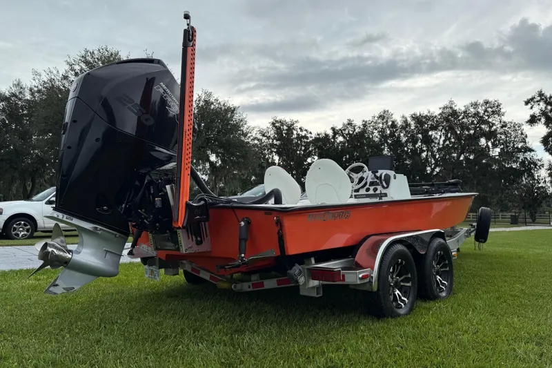 Slide: The Image of 2021 Big O Elite 20 boat with powerful outboard motor on grassy area. - 9