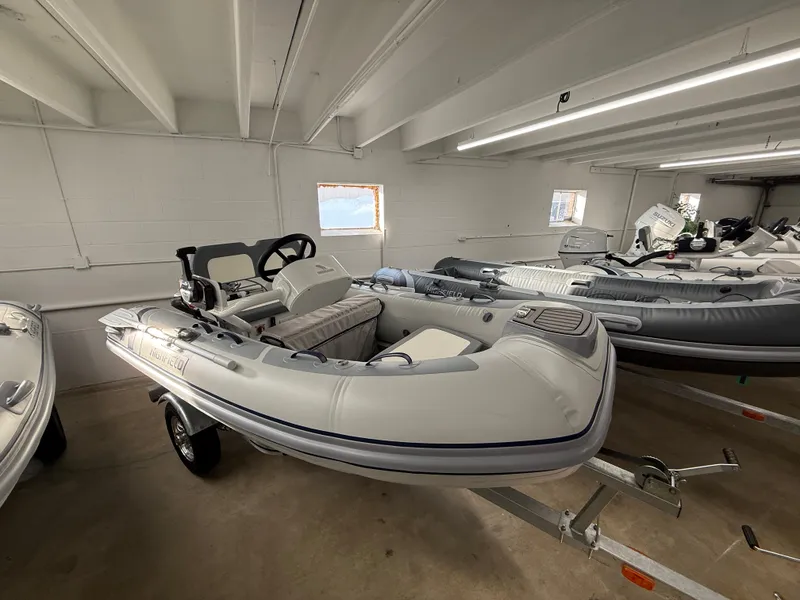The Image of 2025 Highfield Classic 310 FCT inflatable boat in showroom, on trailer. - 0